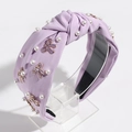 Detail of lavender fabric headband with white faux pearls and a purple metal bow buckle - Light Purple