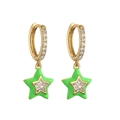 Detailed shot of gold hoop earrings with green enamel stars and cubic zirconia stones - Green