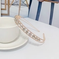 Elegant rose gold metal headband with sparkling crystals shown by a ceramic cup - Single Layer Rhinestone Style