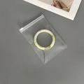Close-up of a green jade bracelet stored in a thickened dustproof EVA jewelry zip bag - 50 Silk Transparent Zipper Bag / 11x16cm