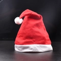 Classic red Christmas hat with white plush trim and pompom on a black background - Non-woven Christmas Hat [Kids]