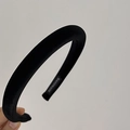 Close-up of a handmade black velvet headband with a high-density satin texture finish - Black