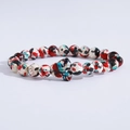 Detail of colorful beads with a butterfly charm on a multi-color beaded bracelet - Colorful Spotted Butterfly Charm