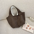 Detailed texture of brown corduroy tote bag with striped velvet fabric and soft inner lining - Wildflower Coffee