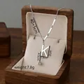 Silver-toned titanium steel K letter necklace set with cube tassel in a wooden jewelry box - Letter K / Silver