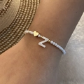 Handmade beaded bracelet with white beads, golden heart charm, and letter Z shell pendant - Letter Z
