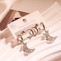 Set of stainless steel earrings featuring moon pendants and studs on a display card - Star Moon Hoop Set
