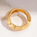 Detailed shot of a wide gold chunky cuff bracelet featuring geometric faceted metal textures - Bracelet-Gold