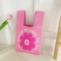 Pink knitted handbag featuring a large floral pattern and Spring Returns lettering - Pink Disk Flower Bag