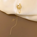 Detailed view of golden ear cuff featuring layered rhinestones, pearls and long tassels - Gold Tassel Earcuff (Single)