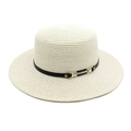 Détail d'un chapeau de paille à large bord avec ruban en cuir noir et boucle dorée - Crème