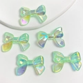 Five holographic green ribbon bow beads in UV luminous resin for DIY phone chains - 1 Bead / Glowing Glitter Light Green