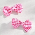 Close-up of pink checkered bow hair clips on a textured white surface, fashion accessory - 2 Pcs/Set / Pink