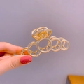Elegante pinza per capelli geometrica in metallo dorato con design ad anelli cavi - Molletta Cava a Cerchi Oro Opaco