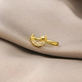 Macro detail of gold moon and star non-pierced nose cuff clip with micro-set zircons - Moon Star (E4751-4)
