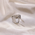 Silver hollow letter U open ring with polished metal finish on silk background - Letter U / Silver