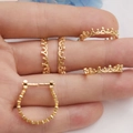 Macro shot of gold-plated crown lace earrings on fingers showing fine details - 14K Gold Crown Ring Base