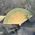 Elegant pale green gradient folding fan made of bamboo placed on natural stones - Beige Green
