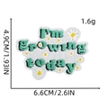 Detail van 'I'm Growing today' geborduurde patch met madeliefjes en groene tekst - Stijl 7# (Ik groei vandaag)