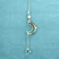 Detailed view of moon and sun suncatcher with colorful chakra stones and crystal ball - Rainbow