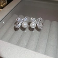 Macro shot of silver bow earrings with sparkling cubic zirconia and hanging white pearls - Silver Bowknot Pearl (21#)