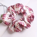 Close-up of white scrunchie with pink LOVE print and soft fabric texture detail - Pink-LOVE