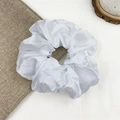 Elegant white satin oversized scrunchie placed on beige linen fabric background - Pure White