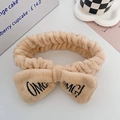 Beige plush OMG headband with bow and black embroidery for face washing and makeup - Khaki