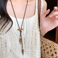 Bohemian wax cord necklace with ceramic wood beads and long fringe tassel pendant - Brown