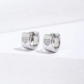 Macro shot of silver huggie earrings with heart-shaped pavé zircon and hinge design - 6mm / Silver