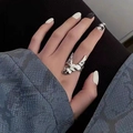 Minimalist silver irregular abstract liquid metal ring on model hand with snake print cuff - Irregular Liquid Ring J0320