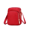 Detailed close-up of red nylon crossbody phone bag with three gold zipper layers - Red