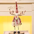 Illuminated skiing reindeer Christmas doll with red striped hat on a wooden base - Swinging Glowing Red (Female)