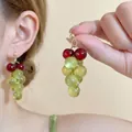 Macro shot of sweet grape drop earrings with green resin beads and golden metal finish - Silver Earring Post - Red Green - Grape