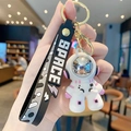 Cool white and pink astronaut keychain with black SPACE silicone strap and gold metal clip - Dazzling Astronaut-Purple