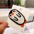 Close-up of cute embroidered penguin hair clip for girls on a white display card - Cute Penguin