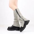 Detail of beige knitted leg warmers featuring a black zipper design and ribbed texture - One Size / Beige