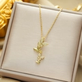 Titanium steel gold butterfly tassel necklace with pavé zircons on beige jewelry box - Gold