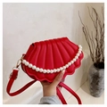 Minimalist red shell-shaped crossbody bag with pearl handle and leather texture - Red