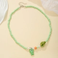 Close-up of beaded necklace with light green pearls and cute sea animal charms - D1666-1 (Light Green Polka Dot Fish Conch)