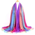 Detailed view of colorful jacquard scarf featuring peacock feather patterns and tassels - Peacock Purple
