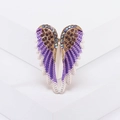Golden angel wing brooch with purple rhinestones and enamel on a white stand - Purple