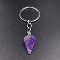 Macro detail of natural hexagonal amethyst crystal pendant with silver metal keychain - Purple Crystal