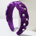 Close-up of a braided purple velvet headband with sparkling colorful rhinestones - Purple