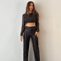 Detail view of women's black sequin tassel two-piece set featuring long-sleeve crop top and pants - S / Black