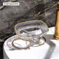 Transparent soap dish with gold trim and metal stand on white ceramic sink - Clear