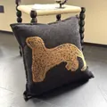 Square dark grey plush pillow with a golden leopard print and black piped edges - Wide Border Black Background Yellow Leopard