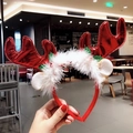 Detail view of a Christmas reindeer headband with red antlers and soft white feather trim - Large Bronzing Red