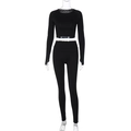 Detail of black long sleeve crop top and high waisted tight yoga pants on mannequin - S / Black