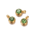 Detailed view of three gold-plated round green zircon charms with small rings - 10 Pieces per Pack / Gold Border Green Stone